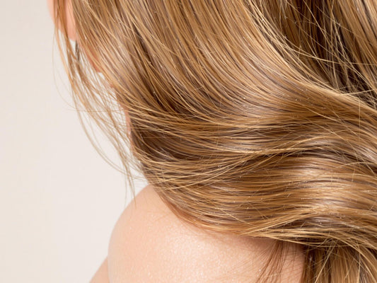 Shining healthy hair cascading over a shoulder.