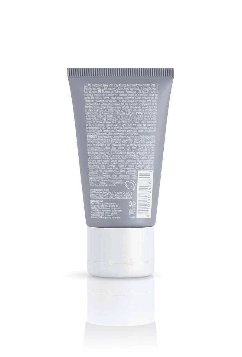 Back view of Neu Repair Treatment Masque tube displaying ingredient list and label for hair repair and nourishment.