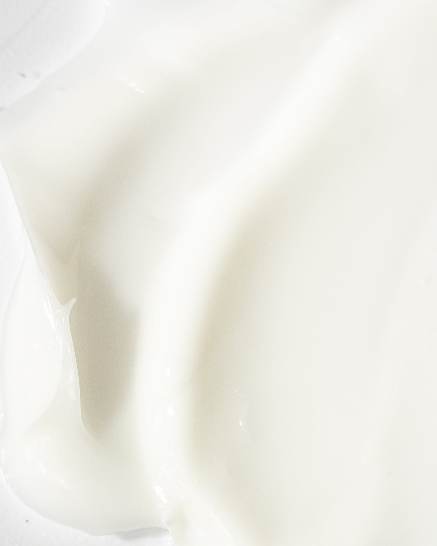 Close-up of a creamy, white moisturizer, showcasing its smooth texture and hydrating properties for dry skin relief.