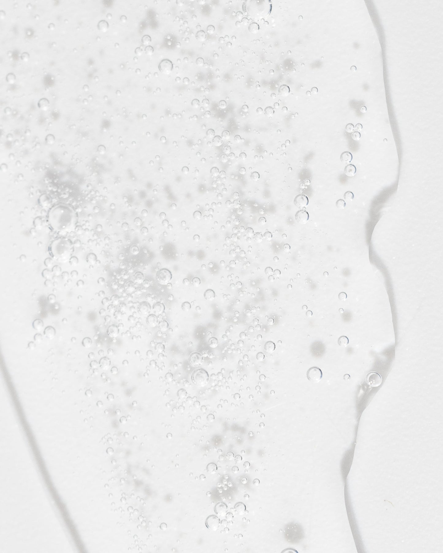Close-up of refreshing toner texture with bubbles, showcasing its gentle, hydrating properties for skin care.