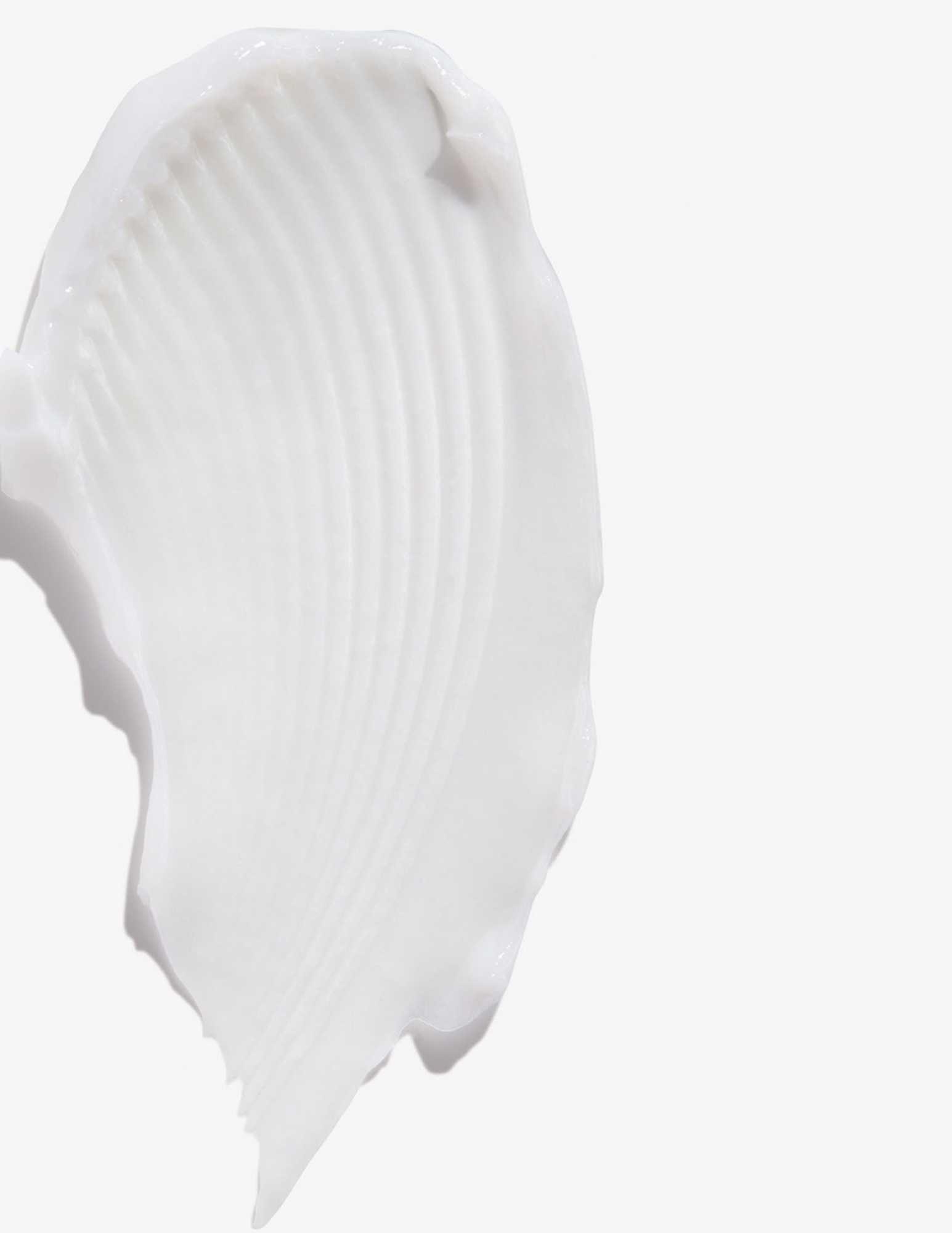 Creamy texture of Redken All Soft Conditioner, ideal for deeply moisturizing dry and brittle hair.