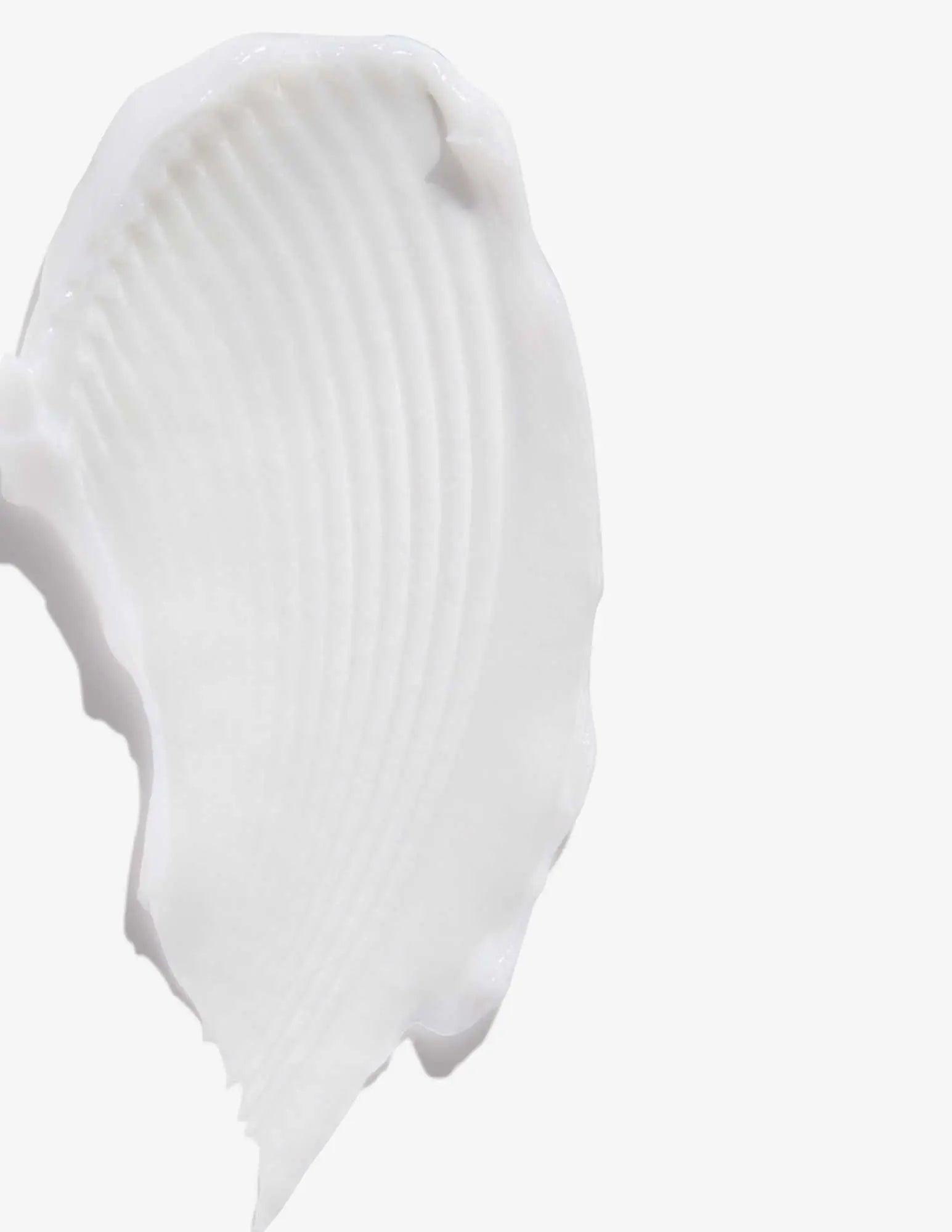 Smooth, creamy texture of Redken All Soft Shampoo swatch on a white background.