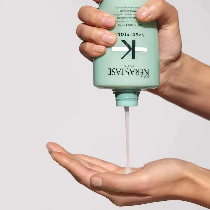 Applying Kerastase hair care product to hand for nourishing hair treatment