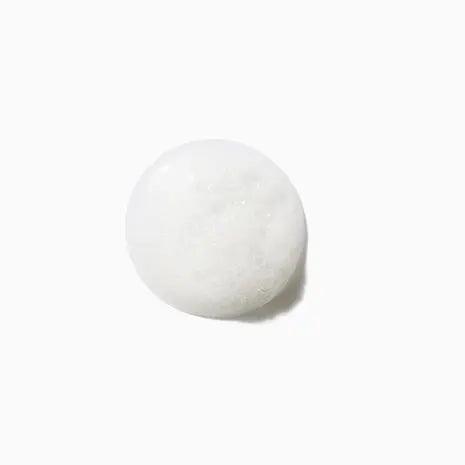 White round bath sponge on a plain background.