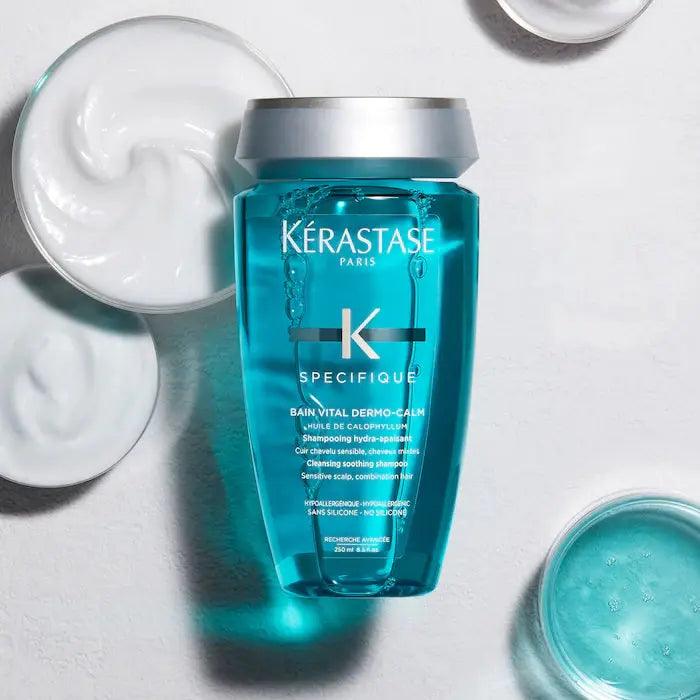 Kérastase Paris Specifique Bain Vital Dermo-Calm shampoo bottle with surrounding creamy and gel textures for sensitive scalp care.