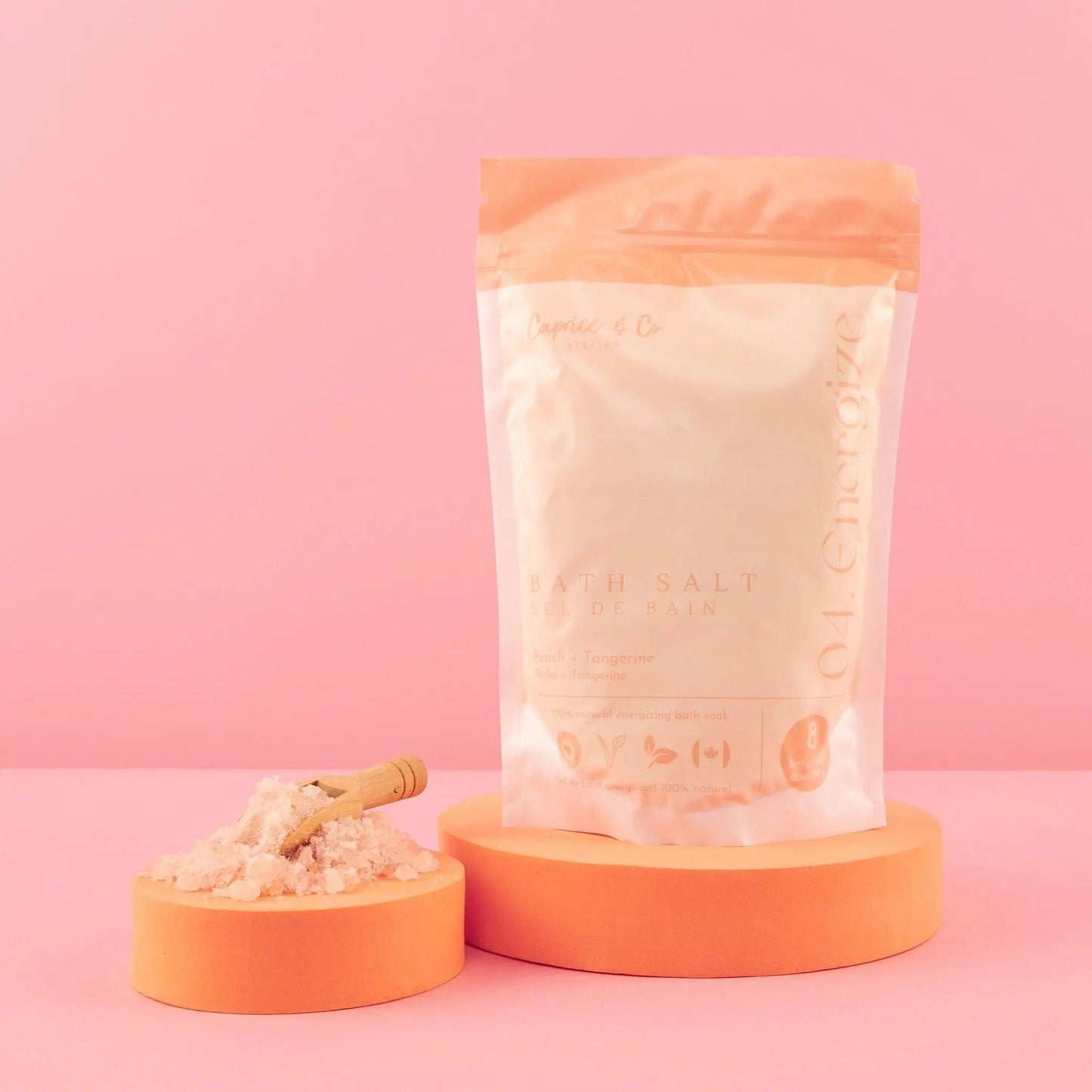 All natural bath salts package with Himalayan pink salts, displayed on orange pedestals against a pink background.