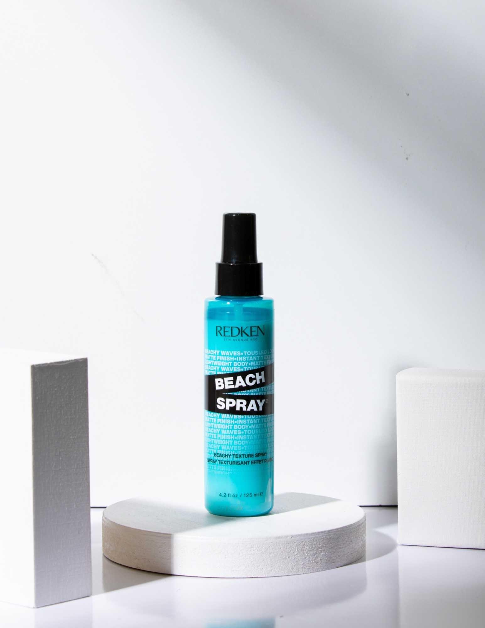 Redken Beach Spray texturizing salt spray in a turquoise bottle for effortlessly tousled, beachy waves.