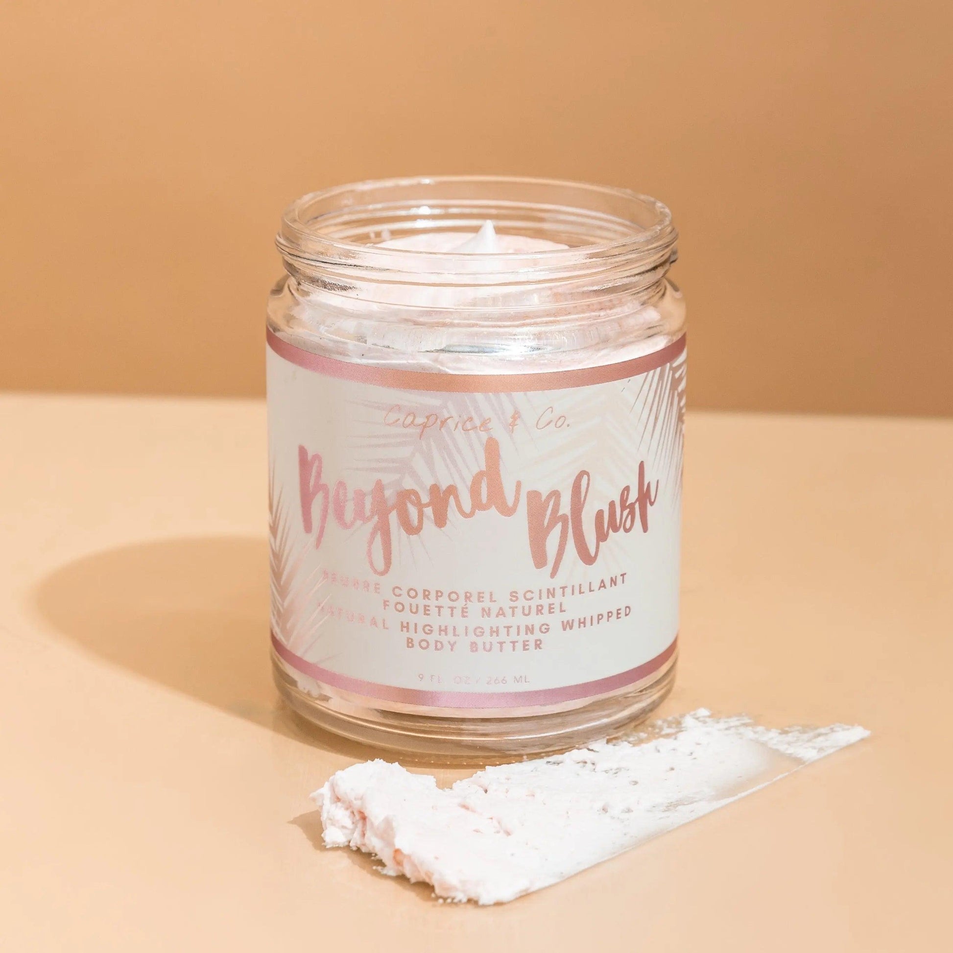 Beyond Blush Highlighting Body Butter jar with whipped formula, featuring rose gold label and moisturizing coconut scent.