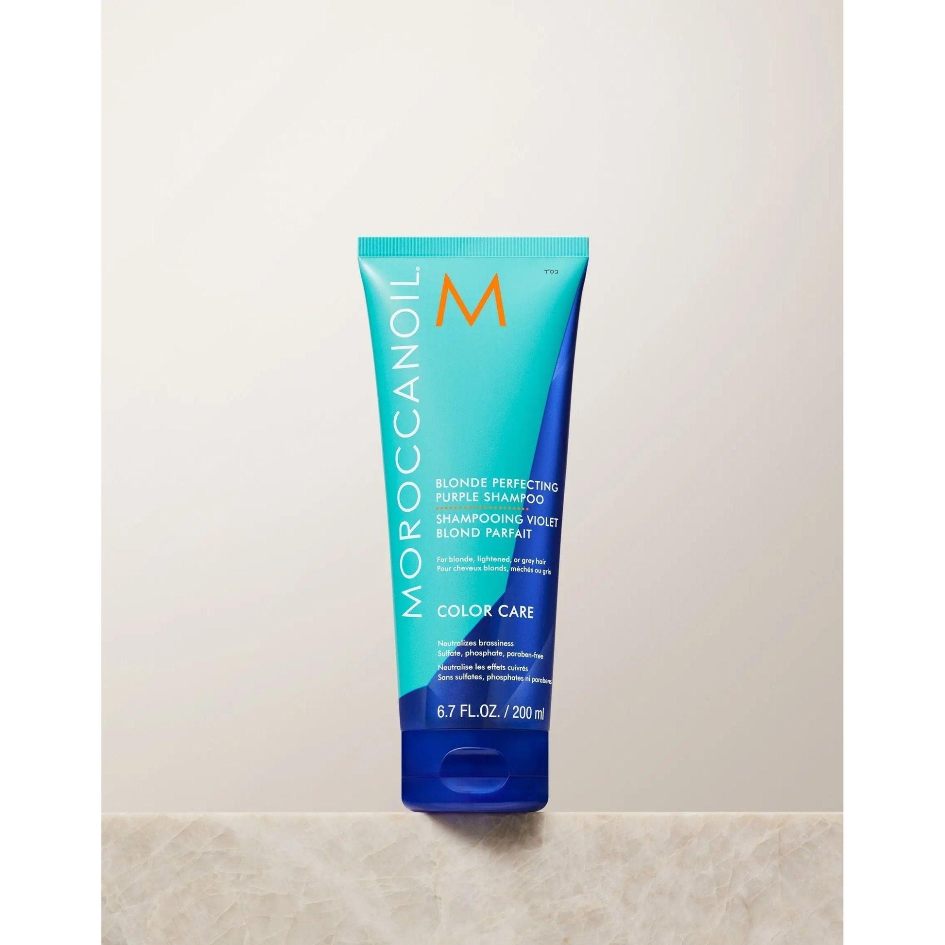 Moroccanoil Blonde Perfecting Purple Shampoo tube for color care, sulfate-free, maintaining cool tones and repairing hair.