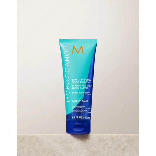 Moroccanoil Blonde Perfecting Purple Shampoo tube for color care, sulfate-free, maintaining cool tones and repairing hair.