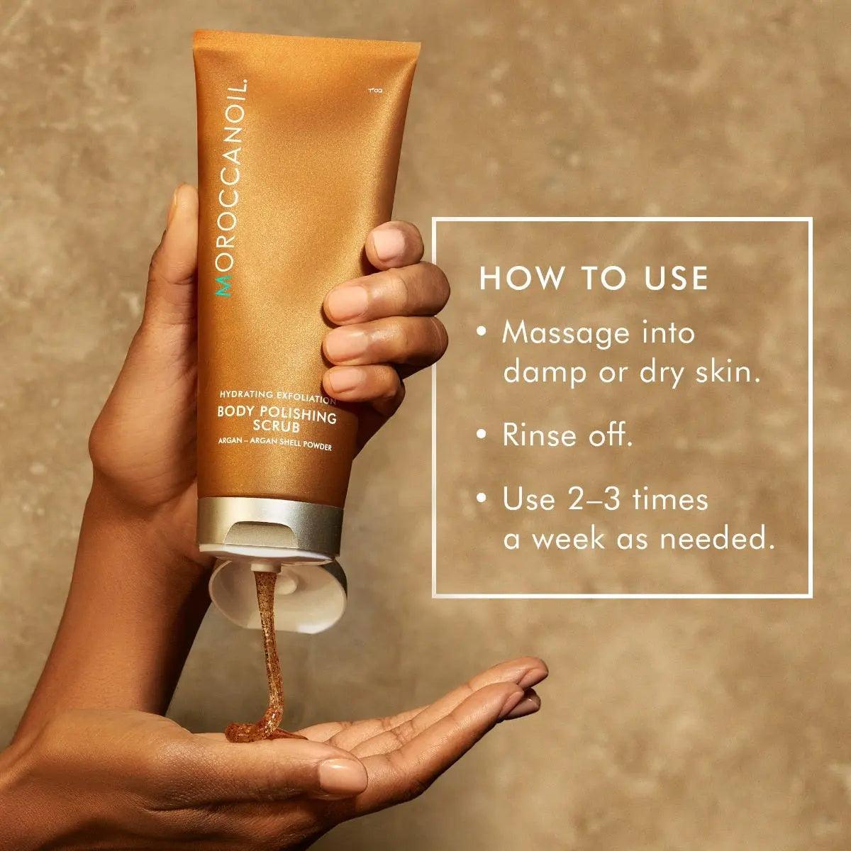 Moroccanoil Body Polishing Scrub Original in hand with usage instructions for exfoliating dry skin.