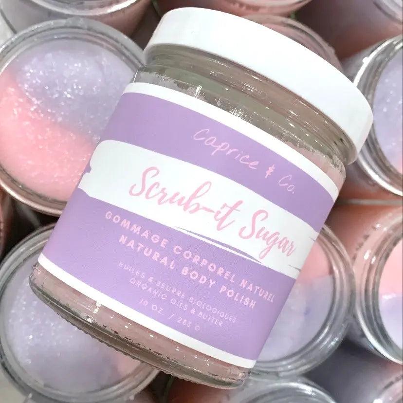 Caprice & Co. Scrub-it Sugar natural body polish jar with pink and purple design, 10 oz size, for gentle exfoliation.
