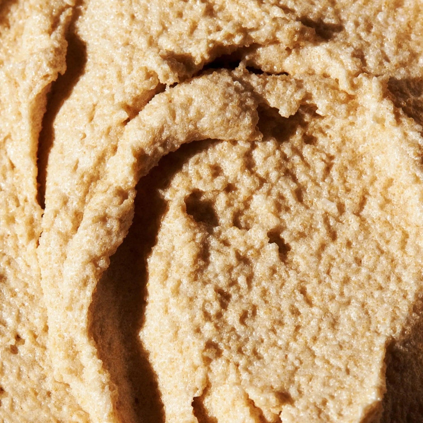 Close-up of Brown Sugar Vanilla Sugar Scrub showcasing its rich, creamy texture for exfoliation and hydration.