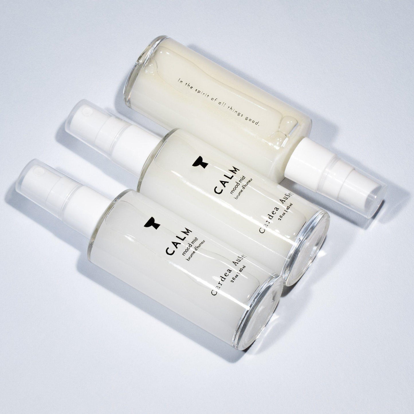 3 skincare spray bottles labeled Calm on light background; calm skin spray for soothing and hydrating face.