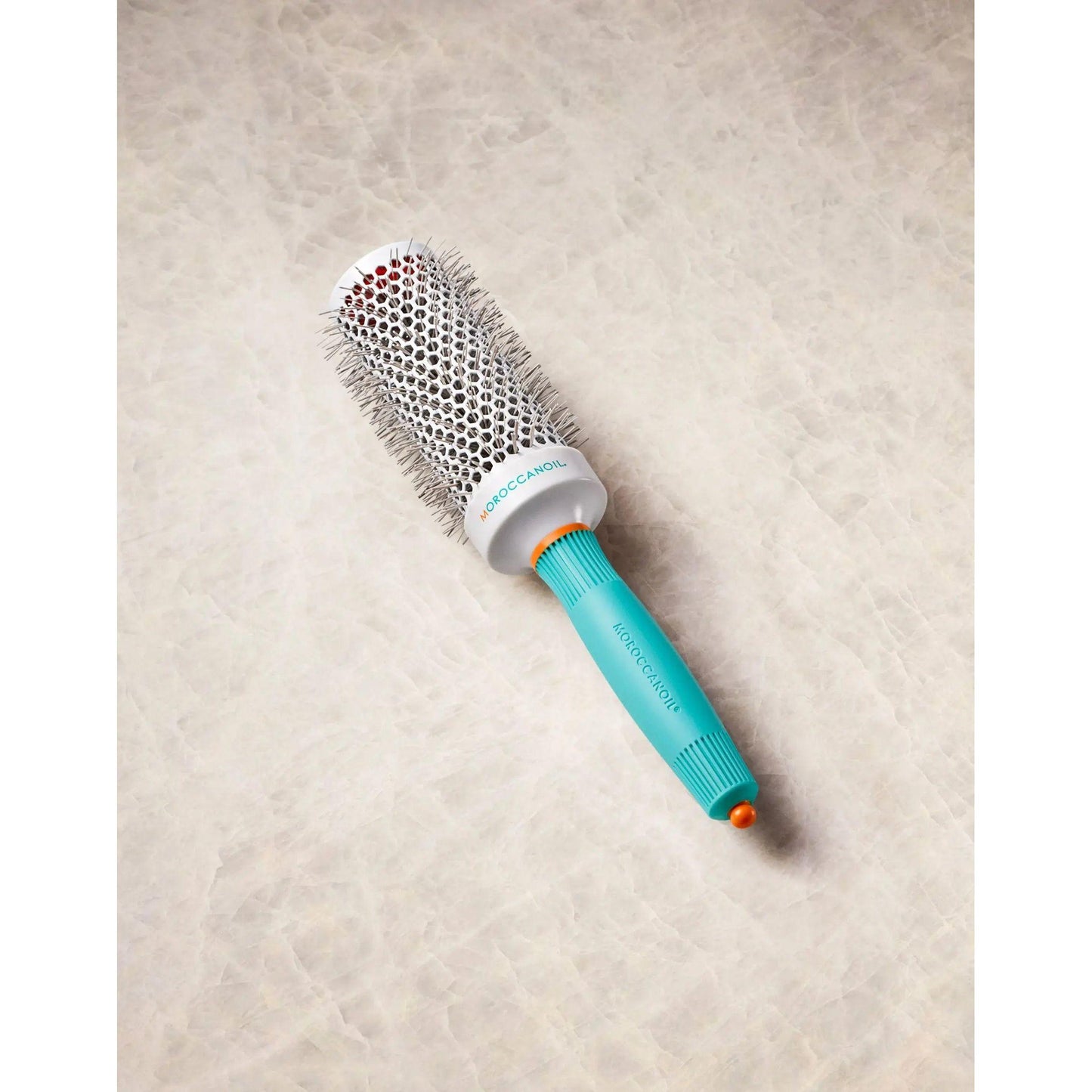 Ionic ceramic round brush with retractable styling clip for faster drying and efficient hair styling.