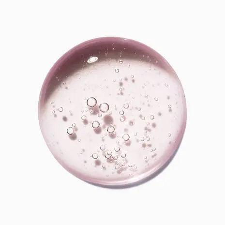 Clear pink gel with bubbles, highlighting the texture of Kérastase Chroma Absolu Bain Riche shampoo.