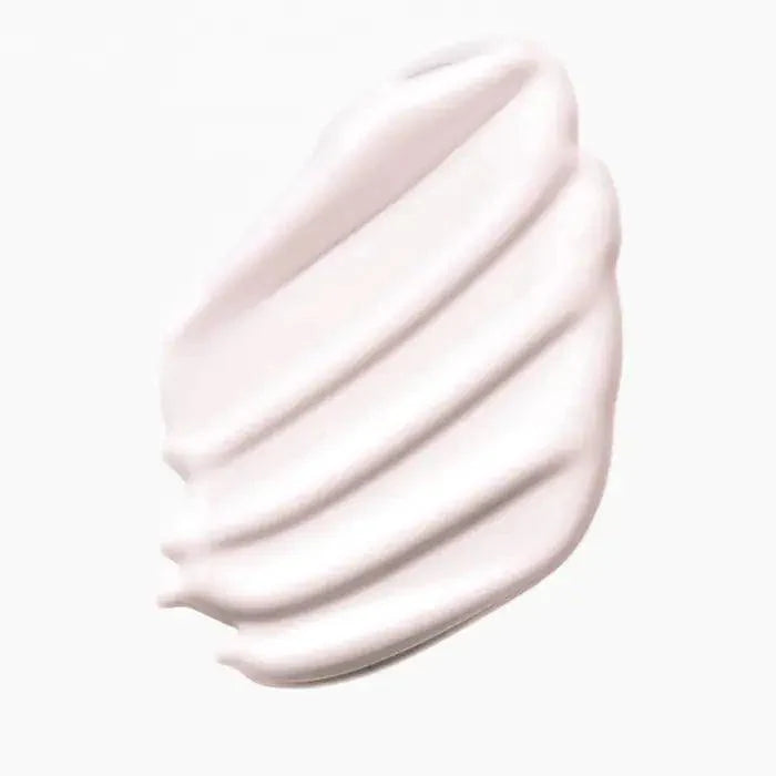 Creamy white skincare product texture detail on white background.