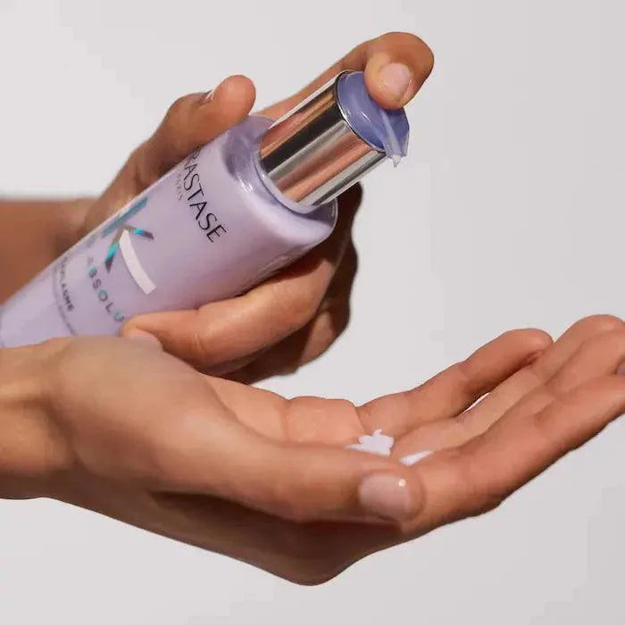 Applying luxury Kerastase hair serum for smooth, healthy hair care.