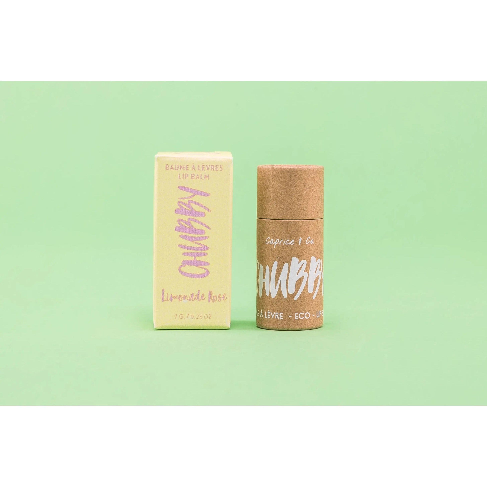 Compostable vegan lip balm with eco-friendly packaging on a green background, perfect for hydration and lip care.