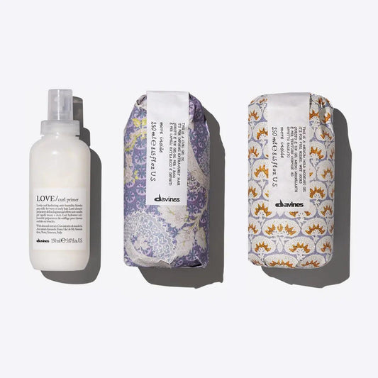 Davines Defined Curls Set featuring Love Curl Primer, Gel Oil, and Medium Hold Gel for defined, bouncy curls.