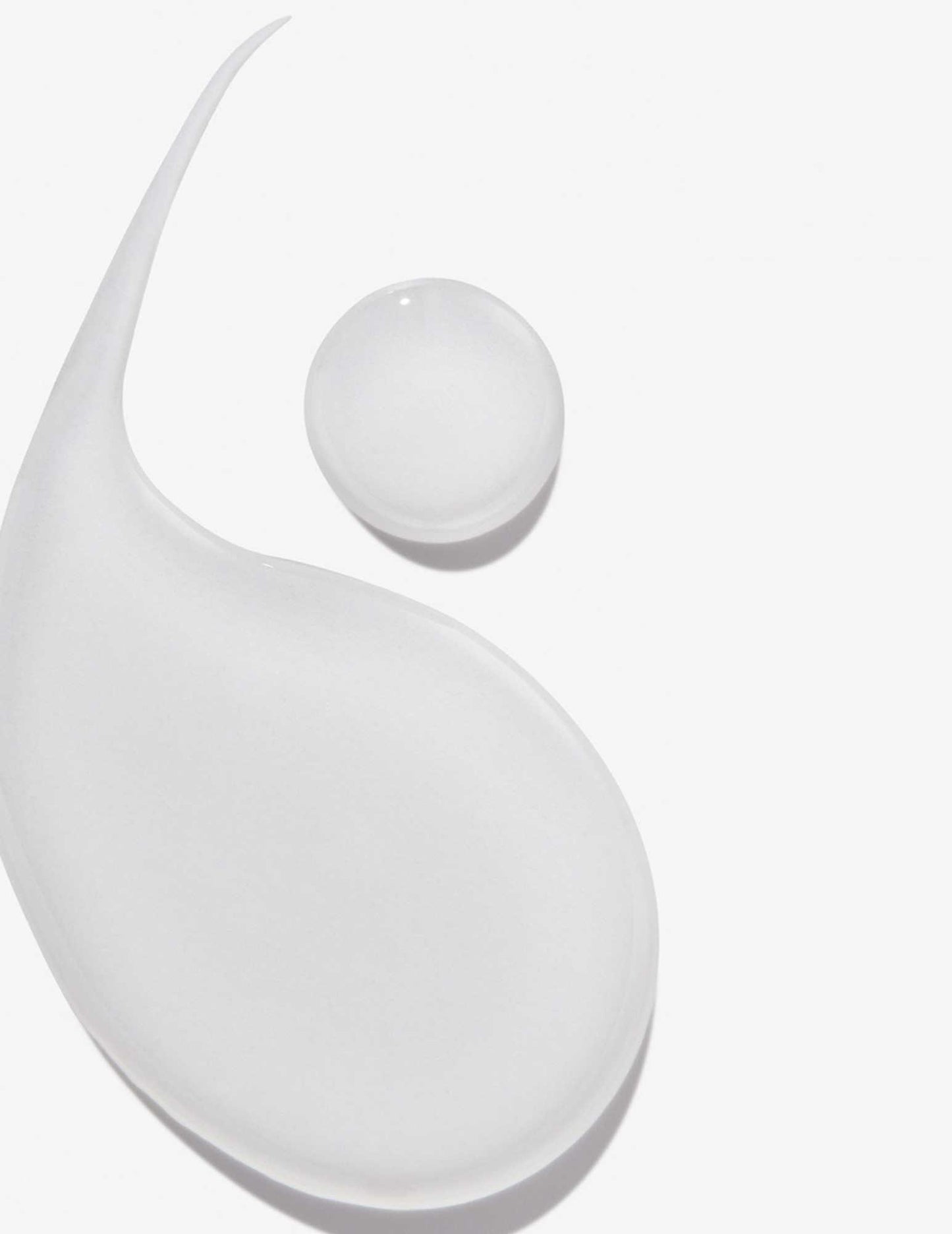 Transparent droplets of shampoo showcasing its smooth texture for healthy hair care.