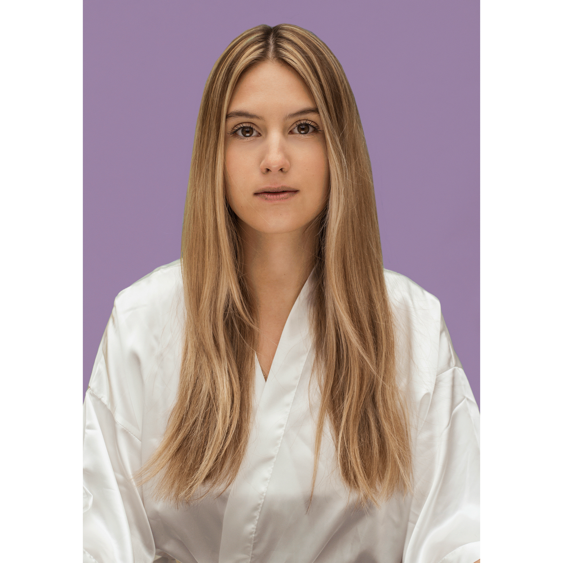 Woman with long, straight blonde hair wearing a white robe against a purple background