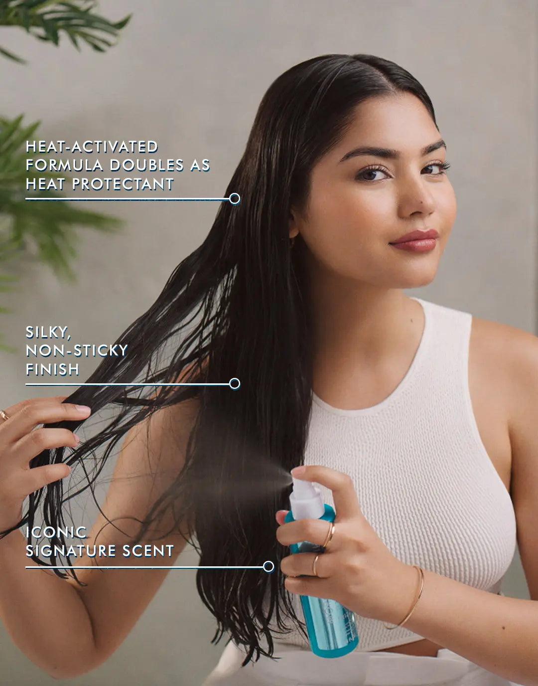 Model using Frizz Shield Spray, showcasing its heat-activated formula and silky finish for frizz control.
