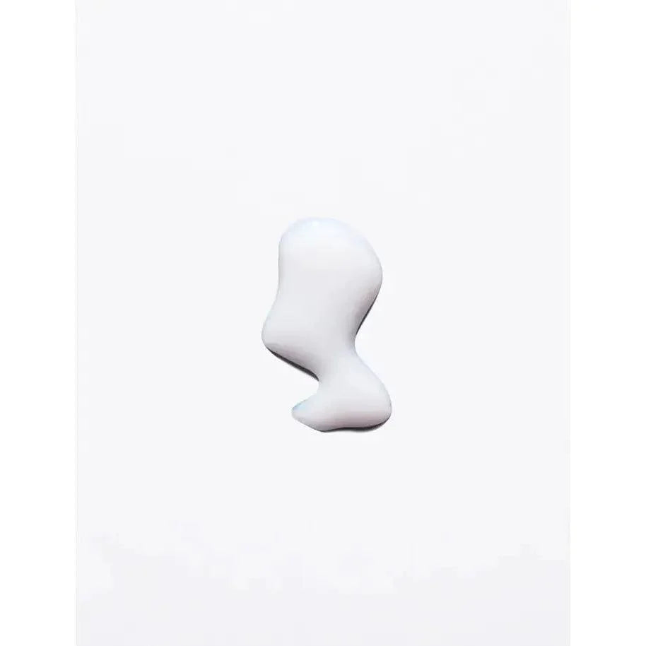 Skincare cream or lotion drop on white background, showcasing texture and consistency.
