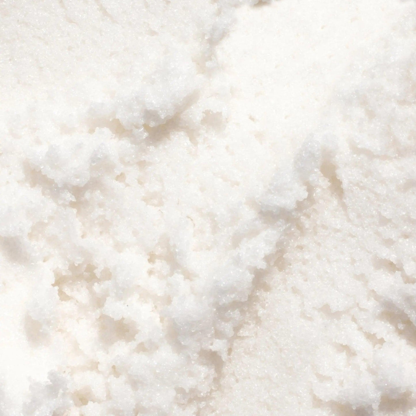 Gilded Woods Body Scrub texture featuring a fluffy, moisture-rich white formulation with pure cane sugar and coconut oil.