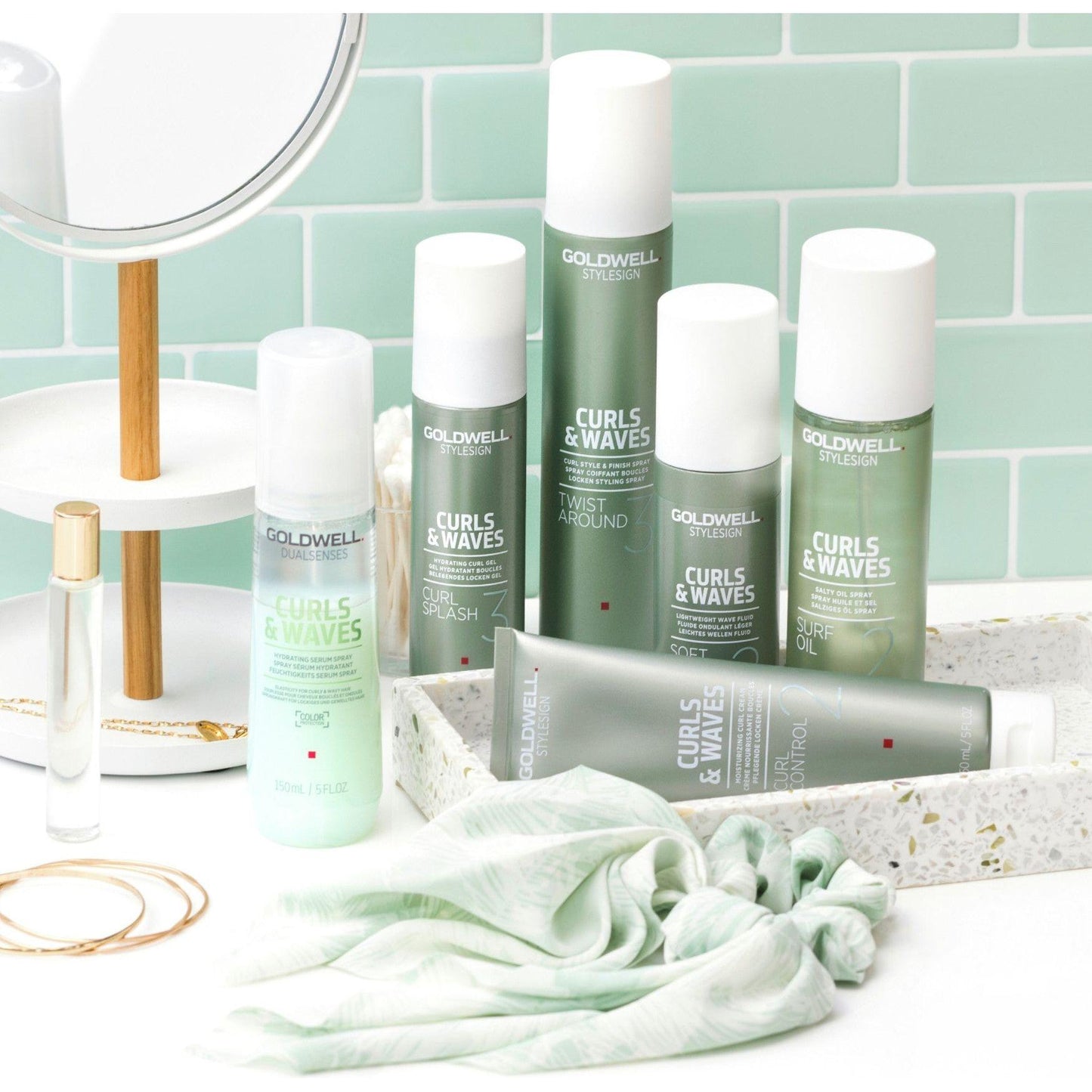 Goldwell Curls & Waves product line on a vanity, featuring hydrating spray and styling products for curly hair.