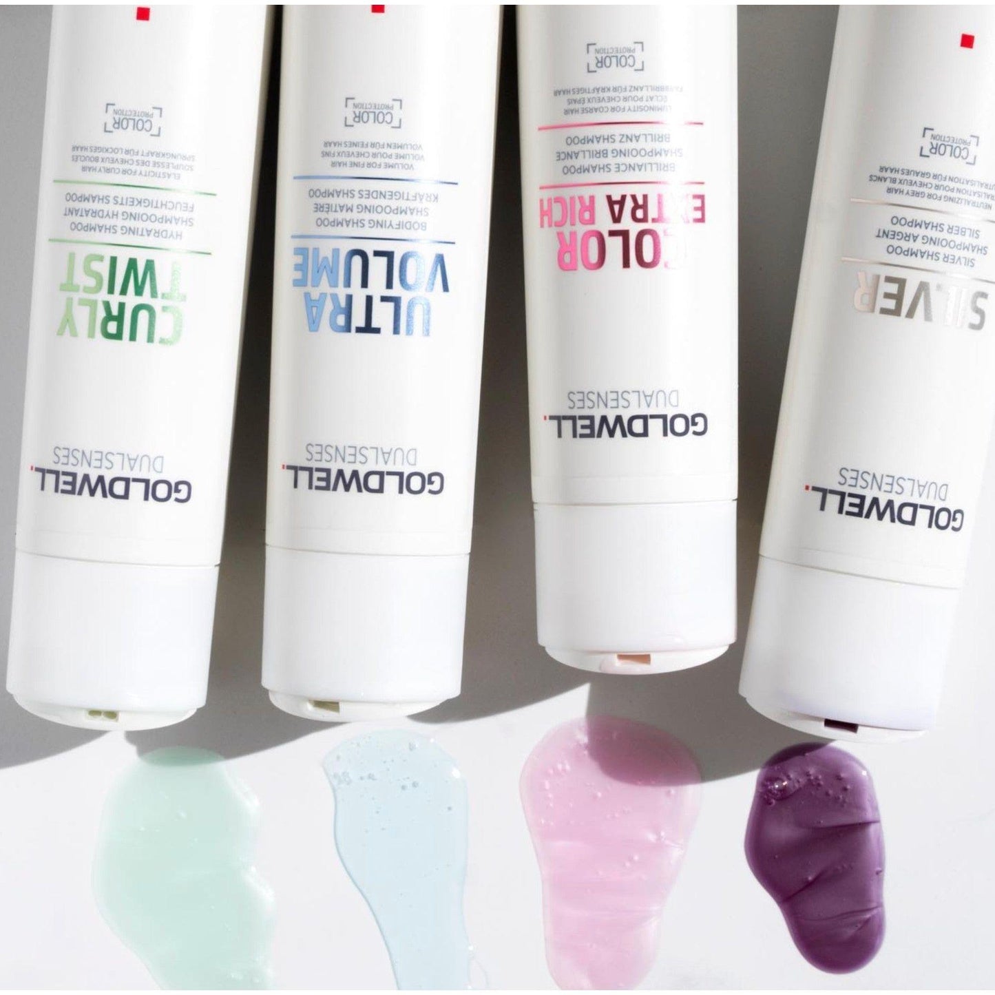 Goldwell Dualsenses shampoo bottles with colorful product samples for curls, volume, color protection, and smooth hair.
