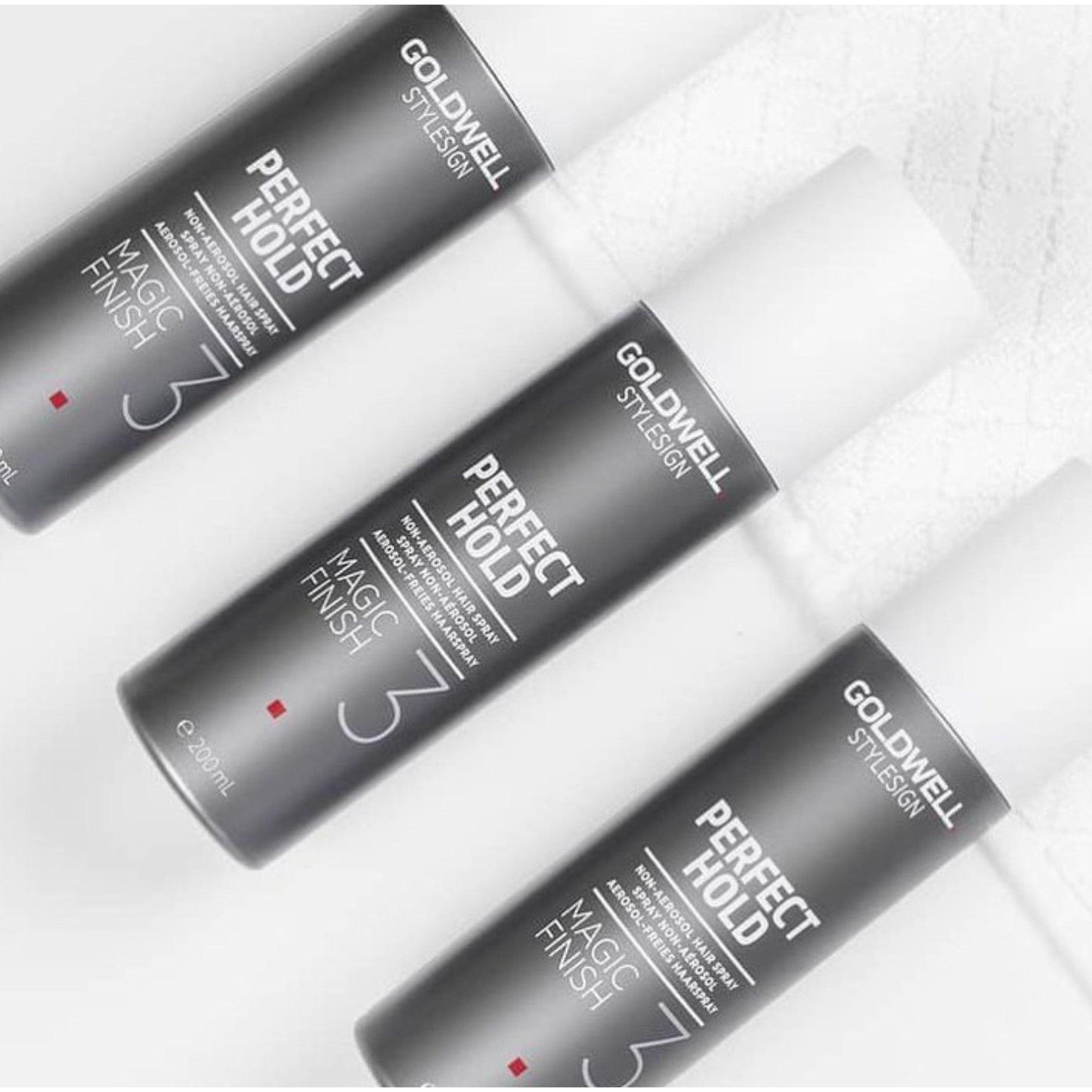 Three Goldwell Perfect Hold Magic Finish Hairspray bottles showcasing light to medium hold and shine.