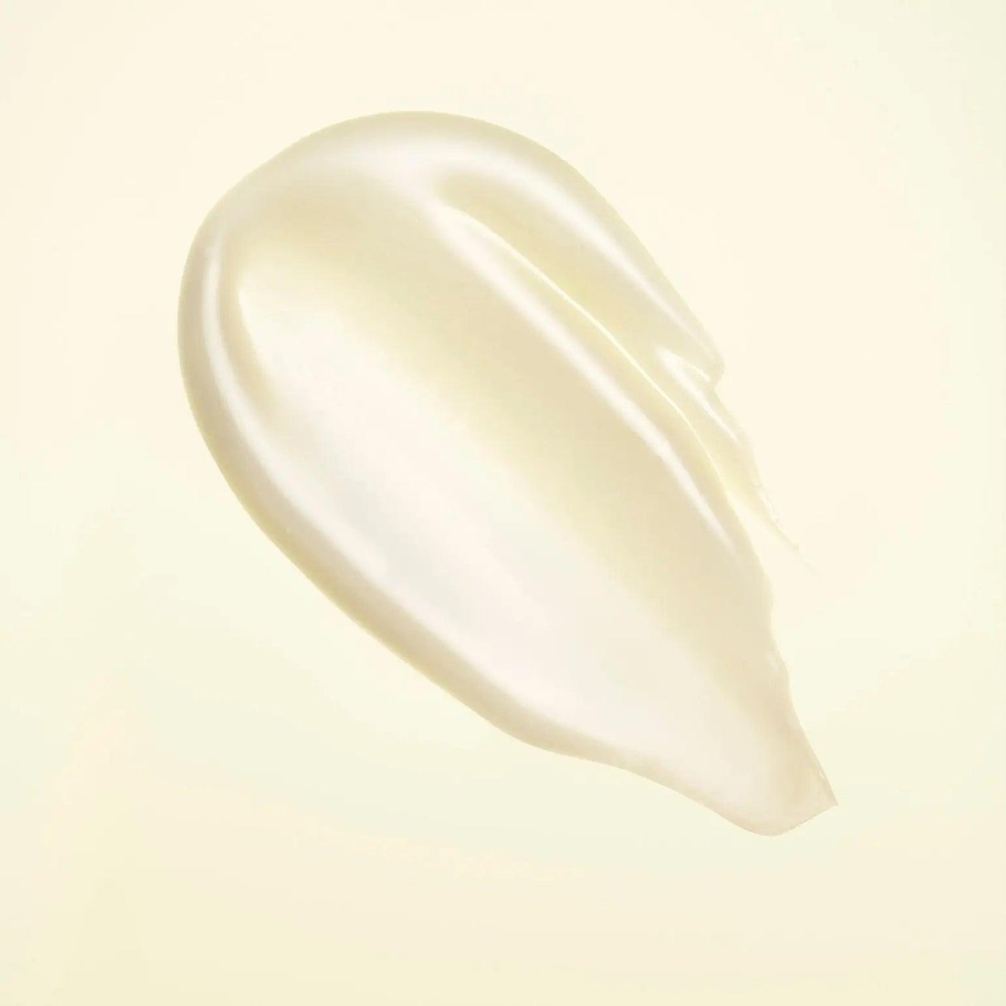 smooth and creamy texture of Hair Alchemy Resilience Conditioner against a soft background