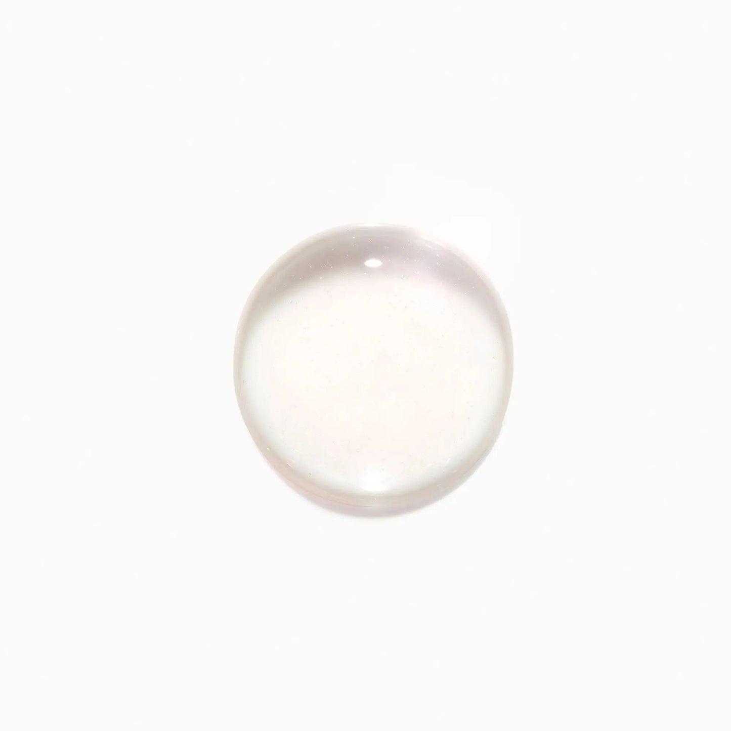 Clear liquid drop on white background.
