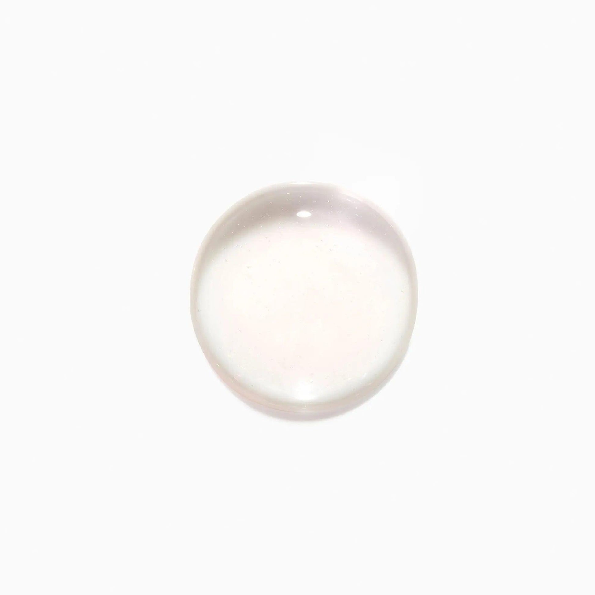 Clear liquid drop on white background.