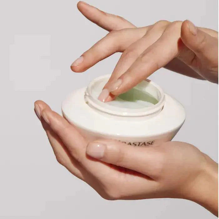Person using Kérastase Spécifique Masque Réhydratant hair mask for deep hydration and scalp nourishment.