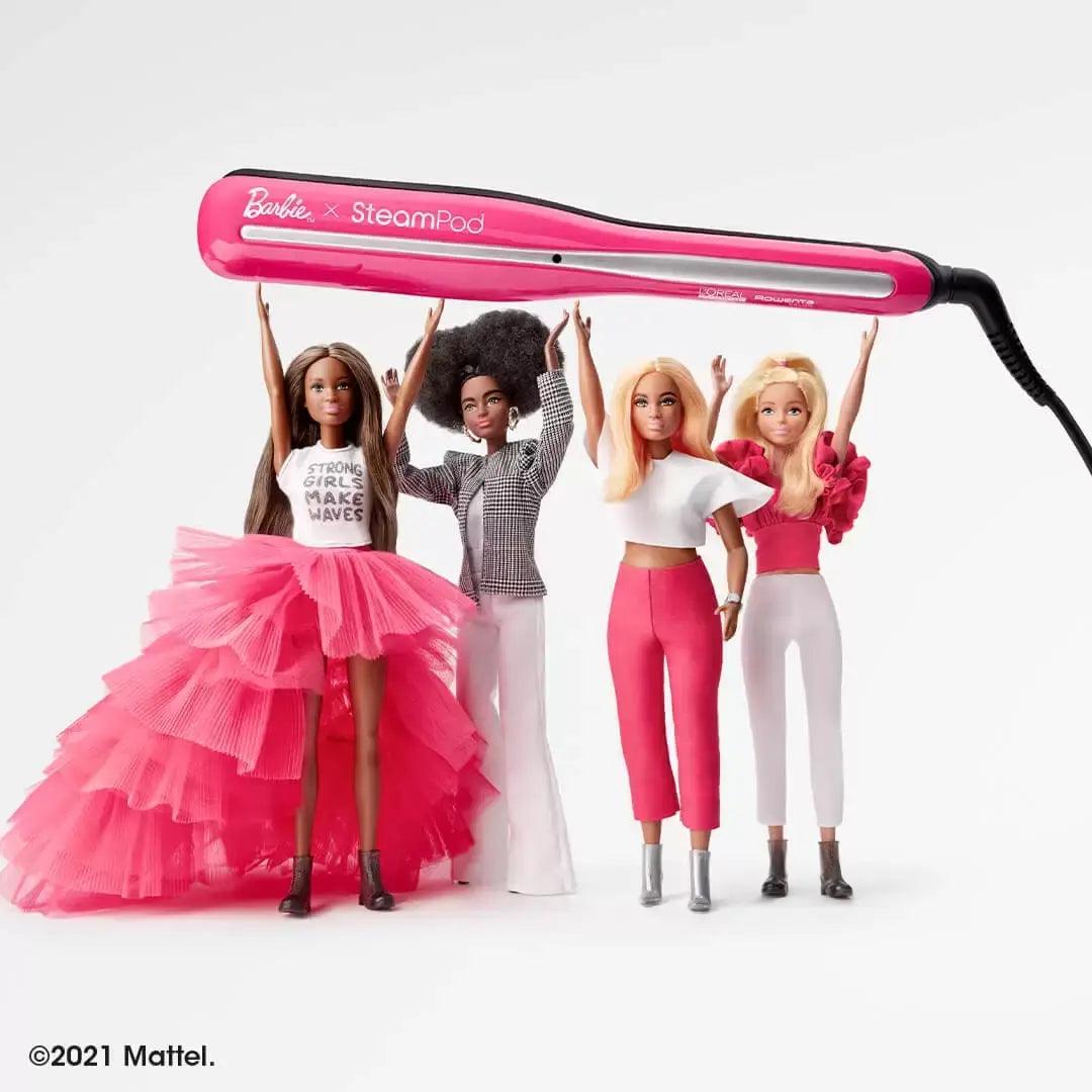 Barbie dolls showcasing the Barbie x Steampod styling tool in vibrant pink, emphasizing fun hair styling.