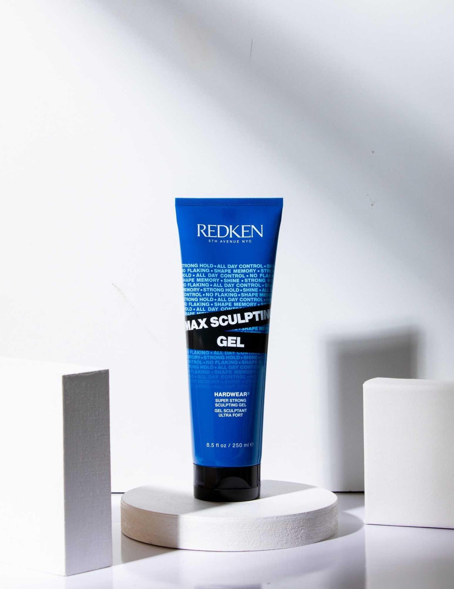 Redken Max Sculpting Gel in a blue tube on display, designed for maximum hold and control for all hair types.