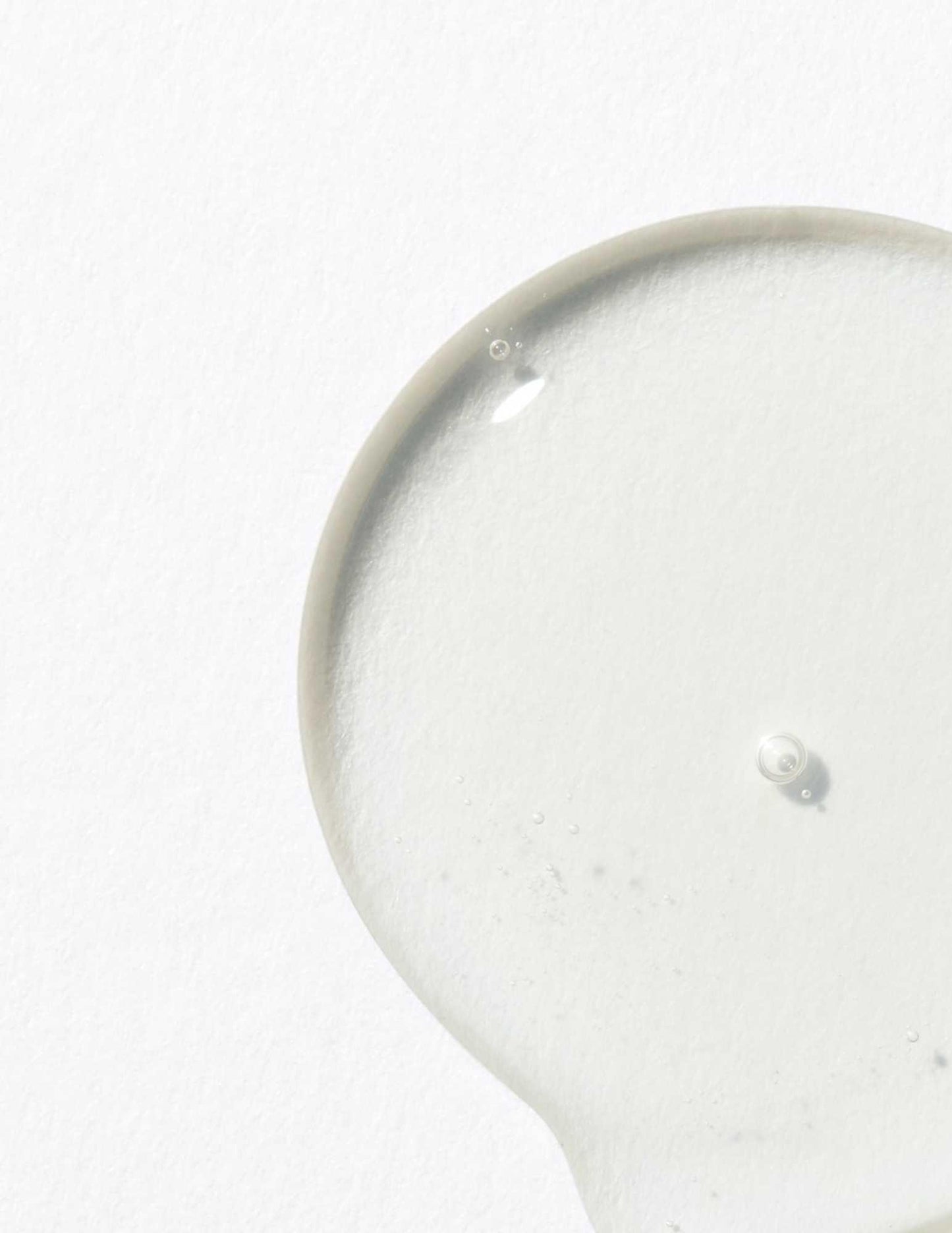 Clear gel drop of Redken Max Sculpting Gel on a white background, showcasing its smooth texture.