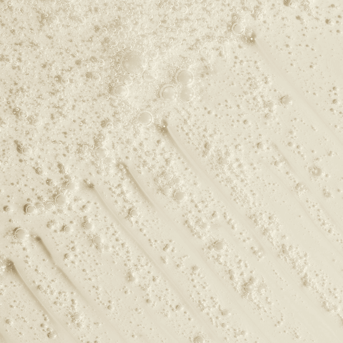 Creamy body wash with bubbles, illustrating a gentle and nourishing formula for sunless tanning aftercare.