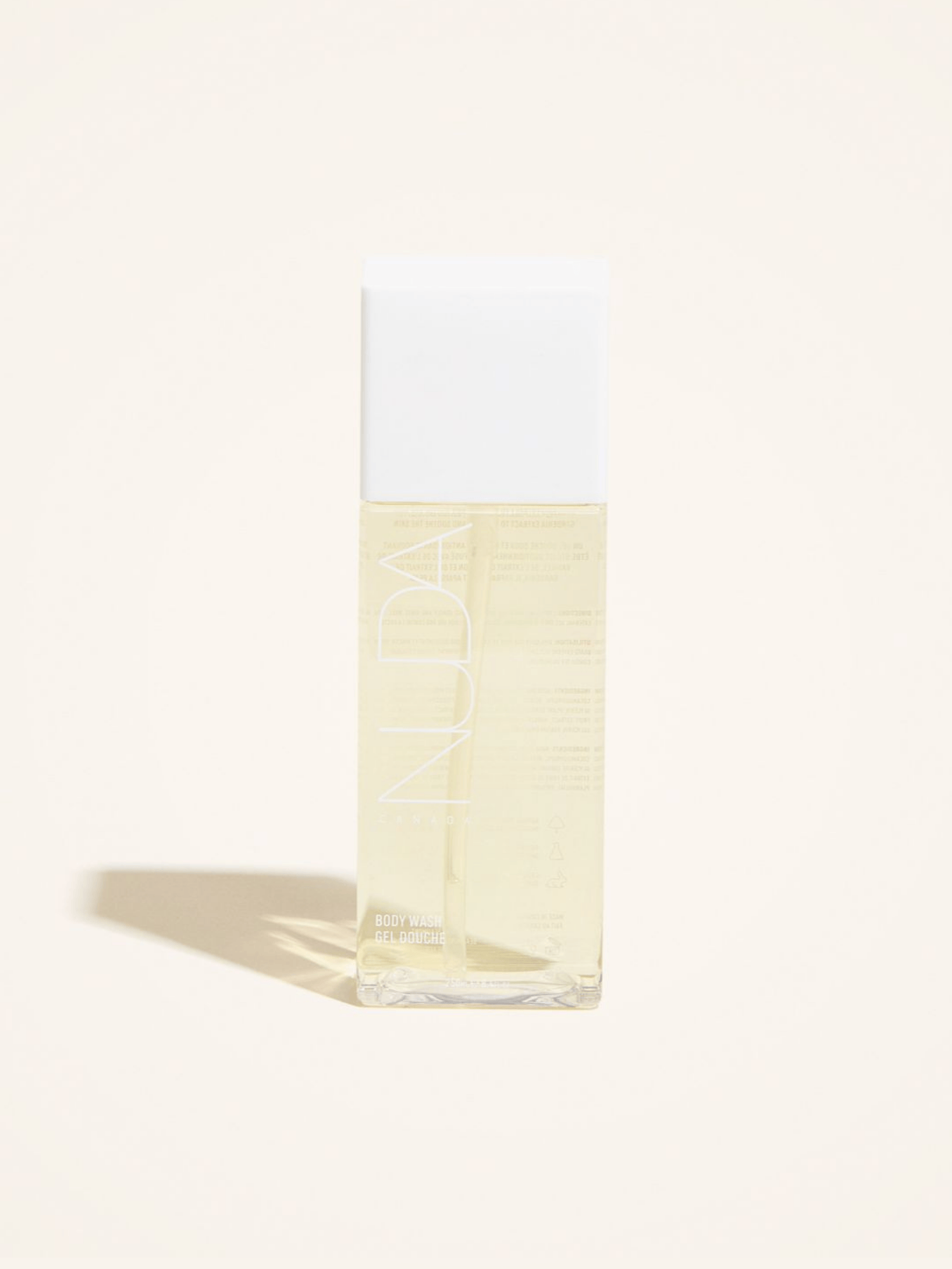 Nuda Body Wash in clear bottle, designed for sunless tanning aftercare with antioxidants and lemon extract.