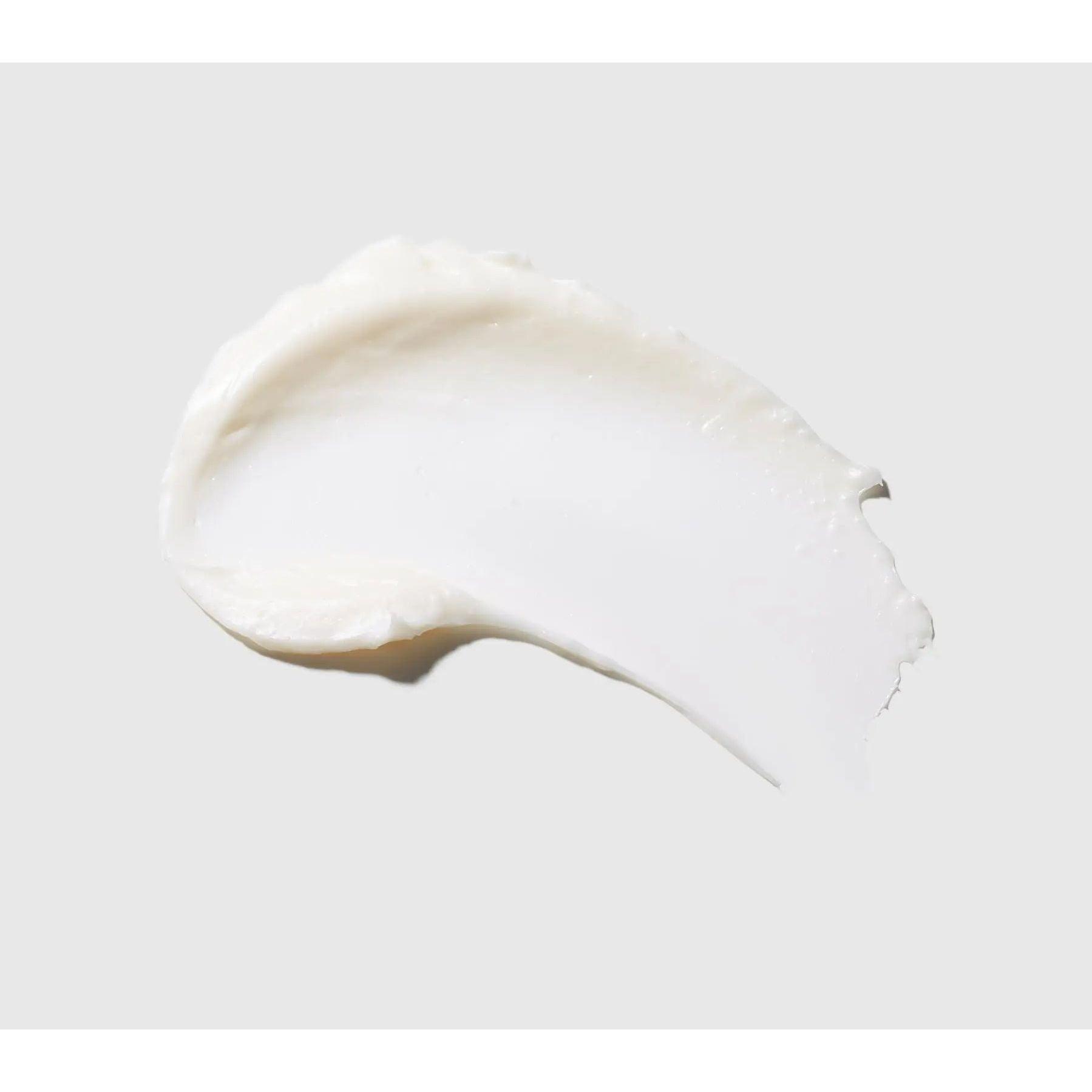 Smooth white cream swipe on light background for skincare and beauty products.