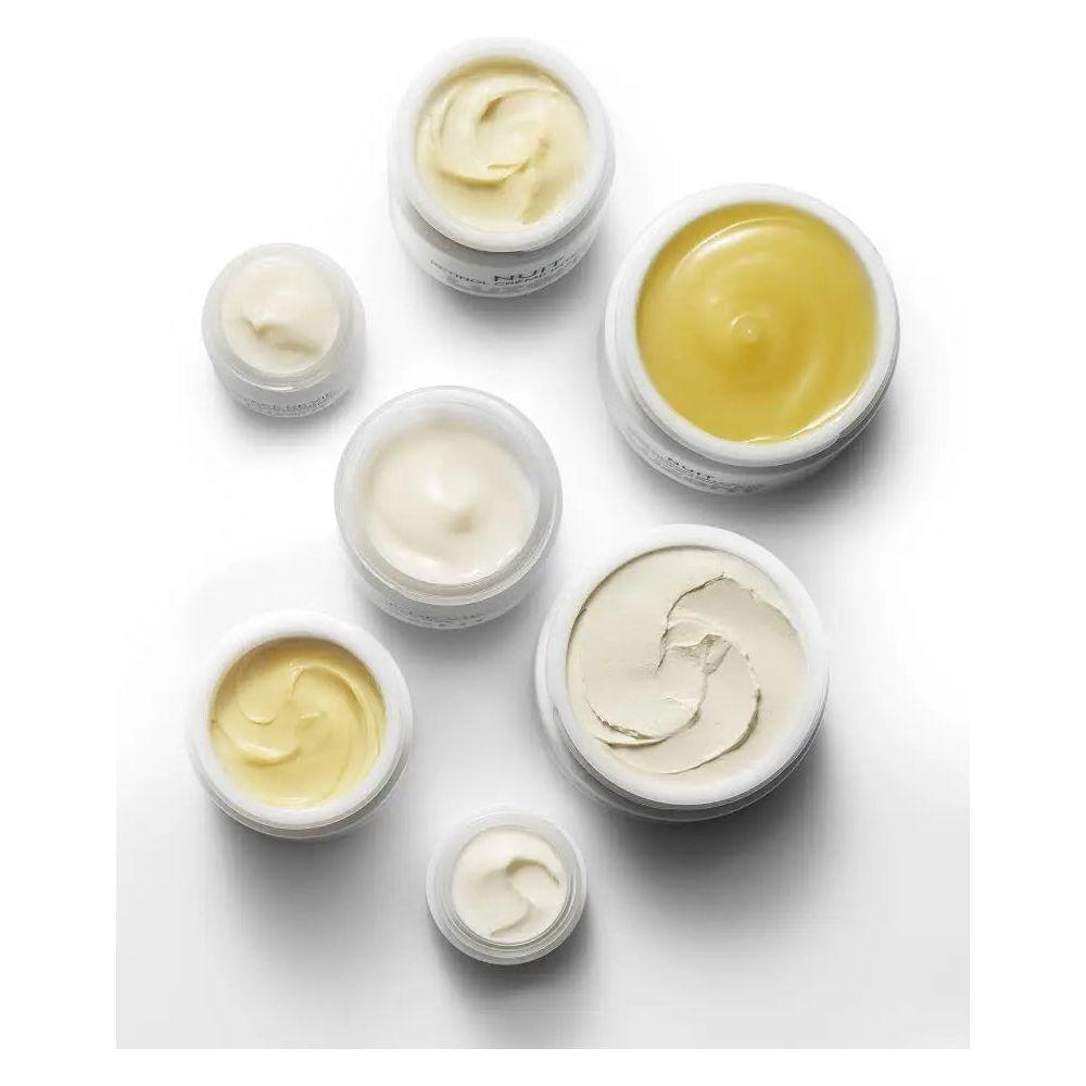 Assorted jars of skincare cream in various consistencies and sizes on a white background.
