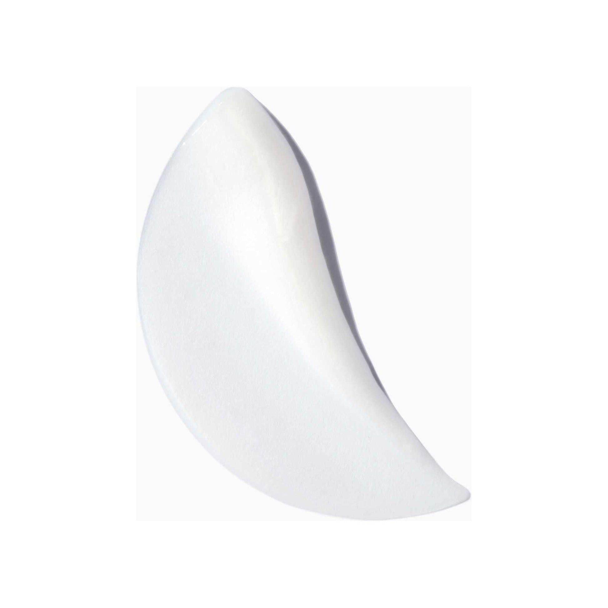 Nutritive Masquintense cream for very dry and fine hair in a smooth, crescent shape against a white background.