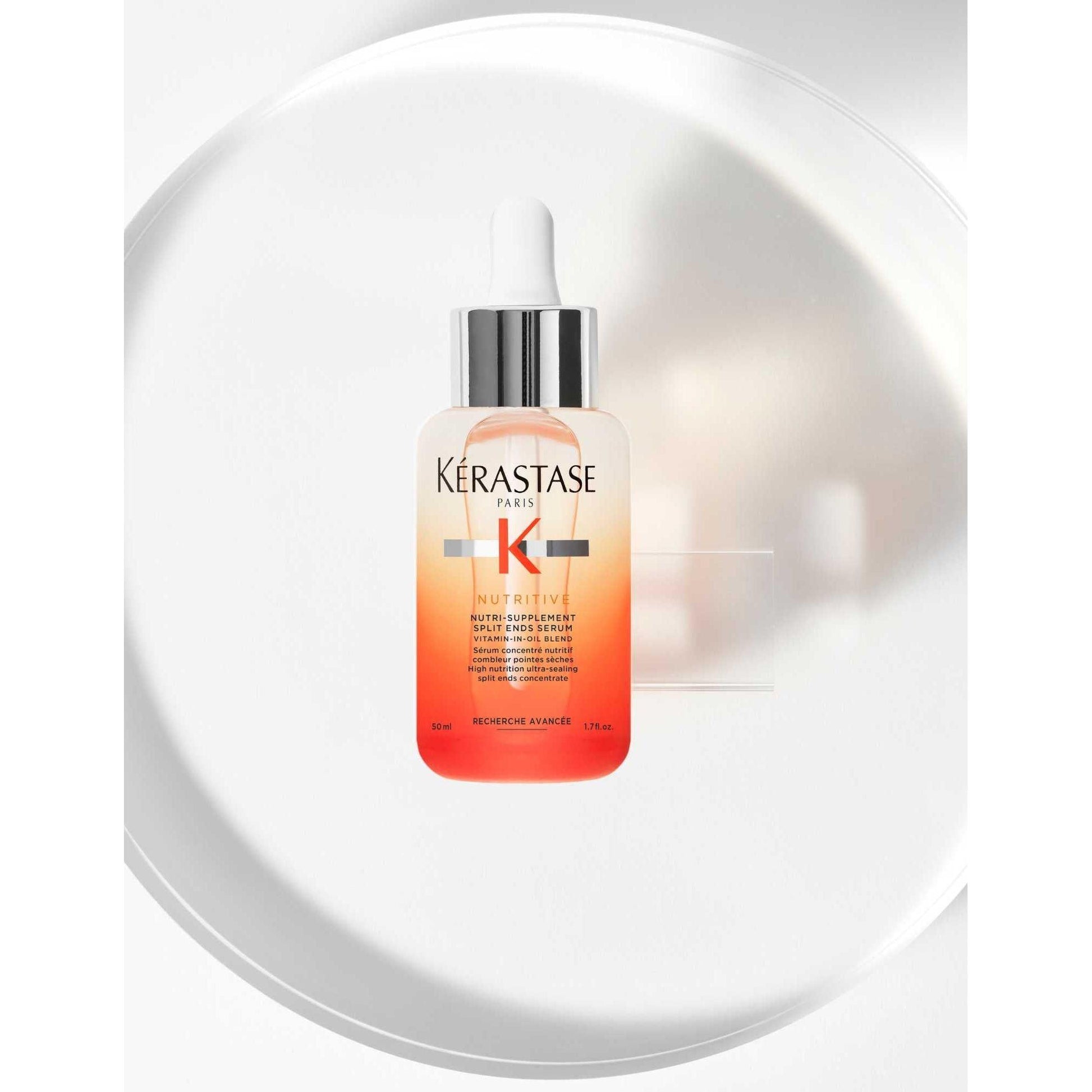 Kérastase Nutritive Nutri-Supplement Split-Ends Serum in a sleek bottle on a minimal white background.