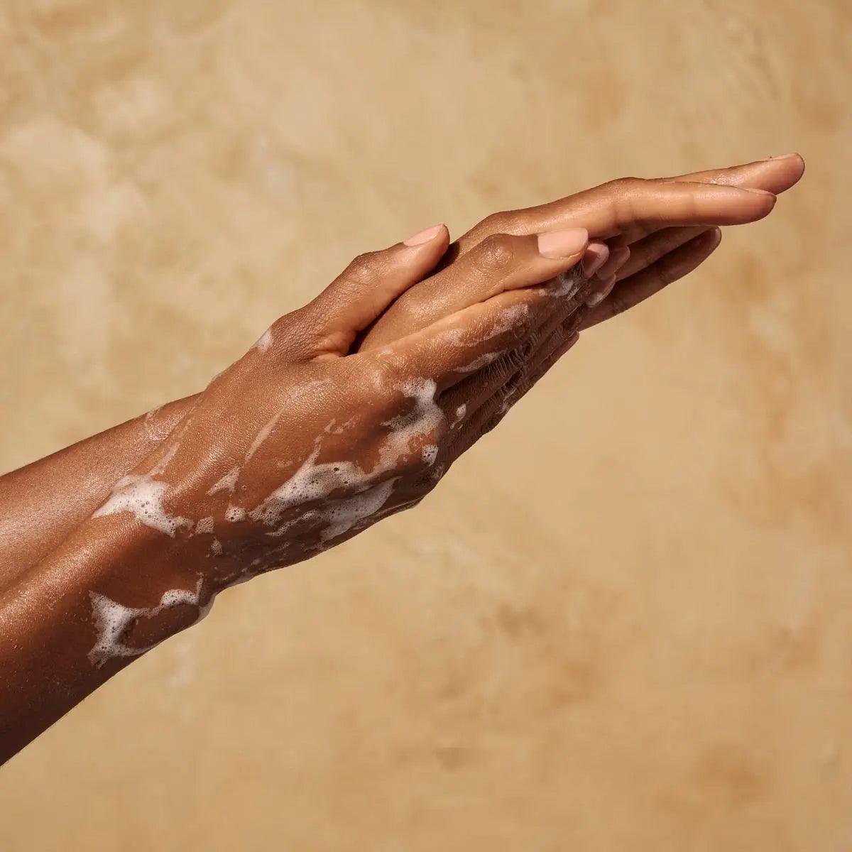 Hands lathering with Originale Fragrance Hand Wash, showcasing gentle cleansing and hydration experience.