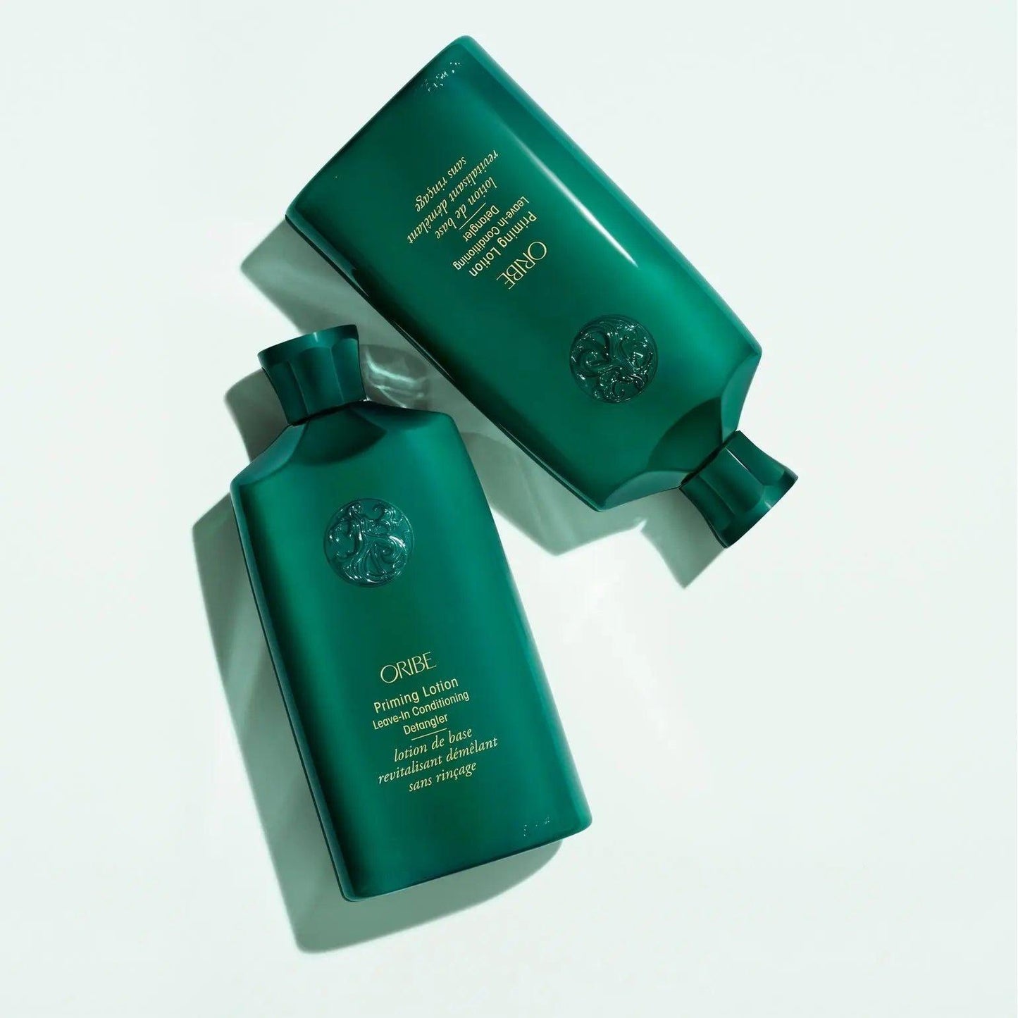 Priming Lotion Leave-In Conditioning Detangler bottles on a light surface, promoting healthy curls and detangling benefits.