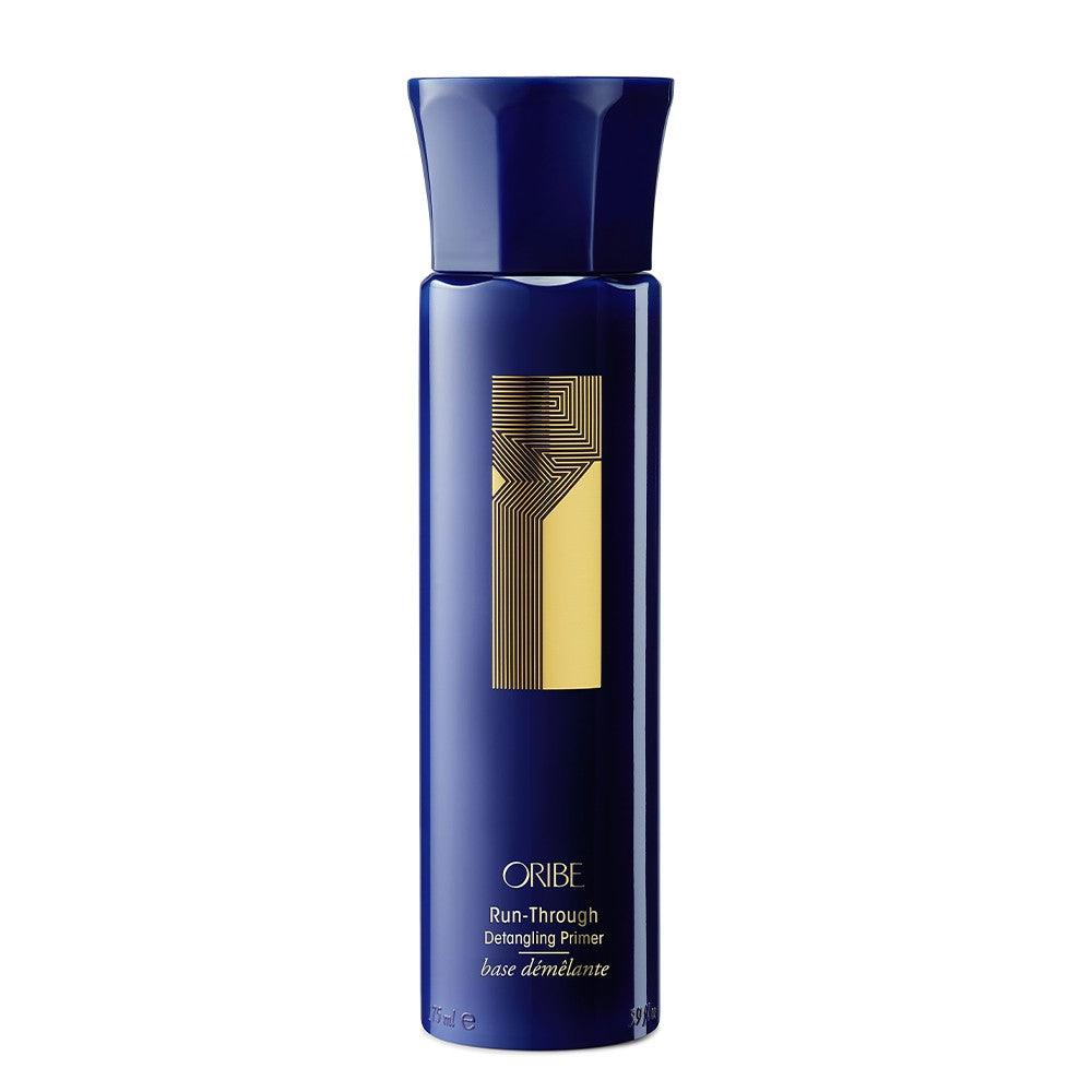 Oribe Run-Through Detangling Primer in blue and gold bottle for shiny, manageable hair