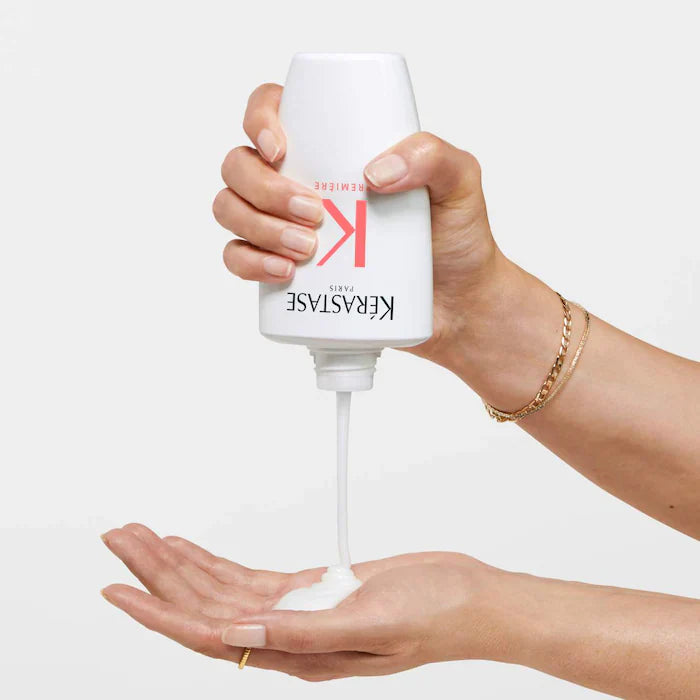 Decalcifying shampoo being poured into a hand, promoting smooth and manageable hair for damage repair.