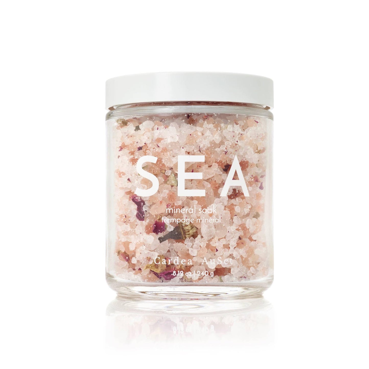 Sea mineral salt bath soak in a clear jar with white lid, perfect for relaxation and skin nourishment. Cardea Auset 240g spa product.